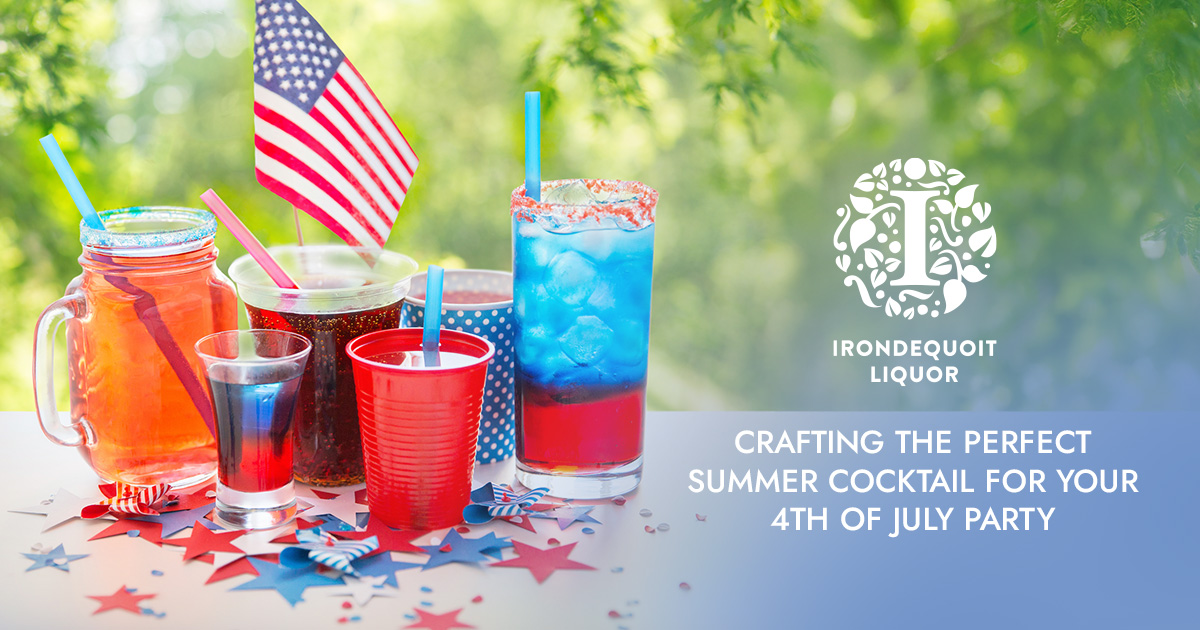 Colorful red, white, and blue drinks with straws and USA flags on a festive outdoor table.