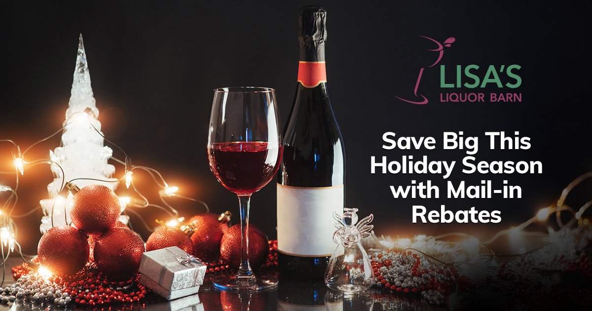a bottle of red wine with a glass of red wine with holiday decorations around it